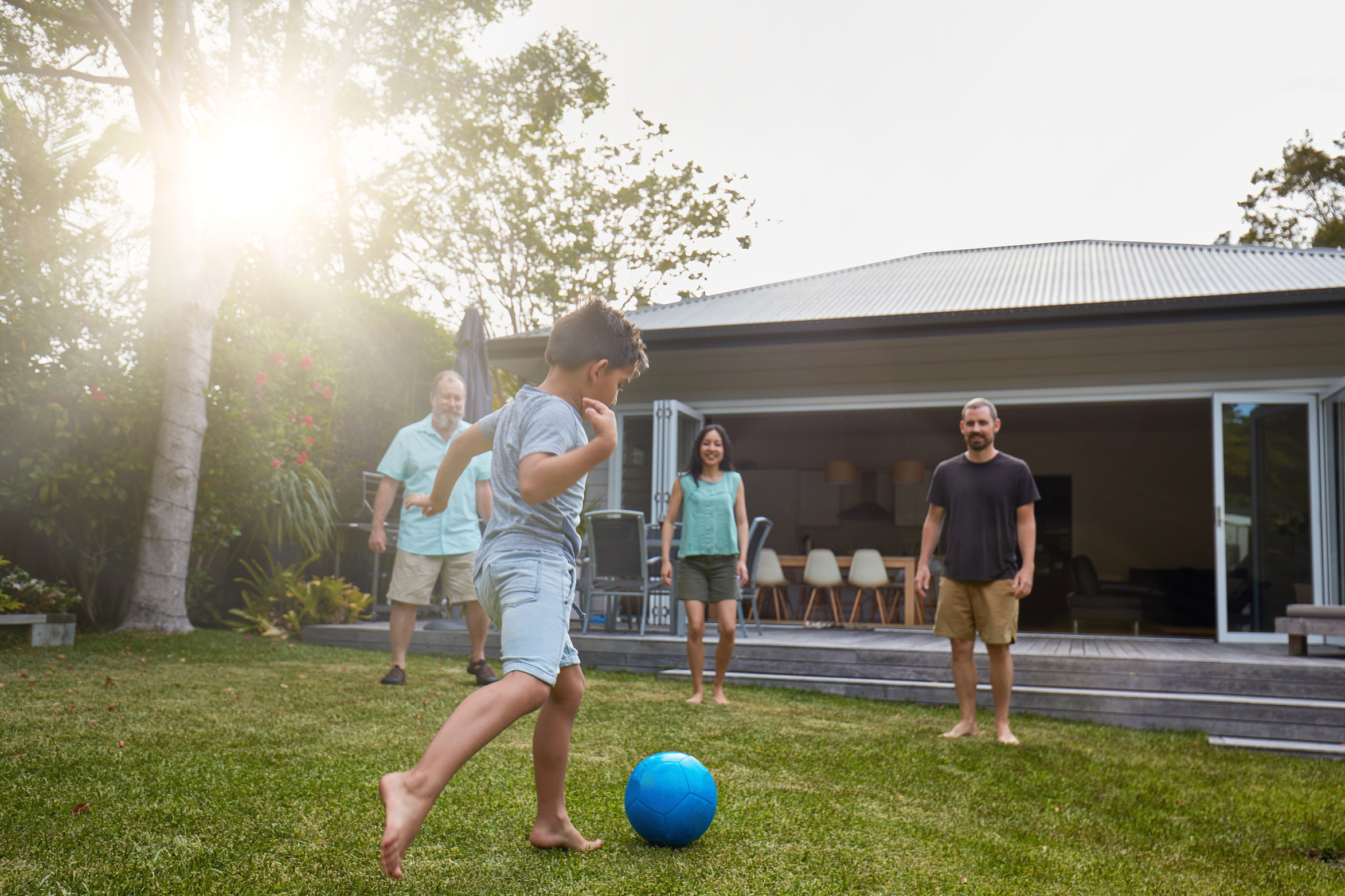 Australian family playing in the back yard garden